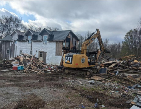 image of a house being torn down